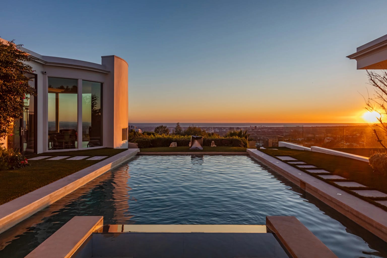 Infinity-edge pool at sunset, looking over Los Angeles to the Pacific